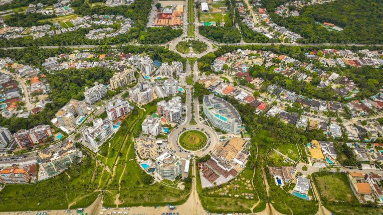Aerial view of a vibrant urban area with circular roads and greenery.